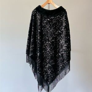 Cato.. Faux fur poncho with silver details and fringe. One size